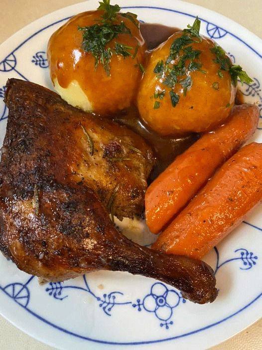 Duck leg with dumplings and baked carrots