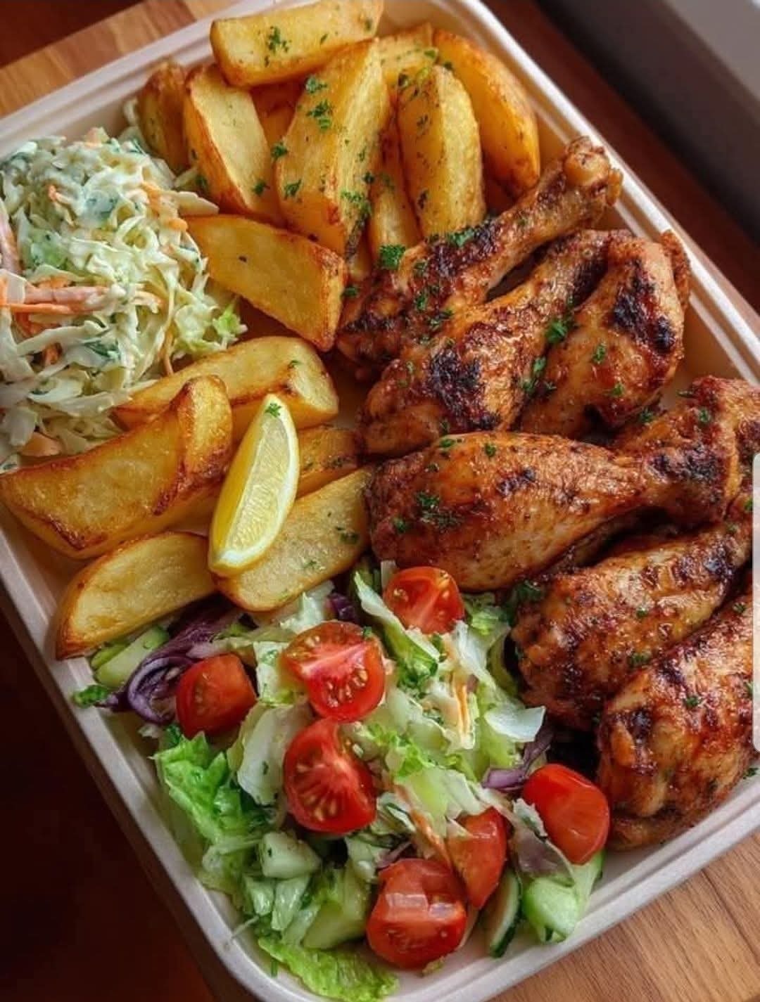 Chicken Drumsticks, Potato Wedges, Greek Salad, Coleslaw and Lemon Wedges